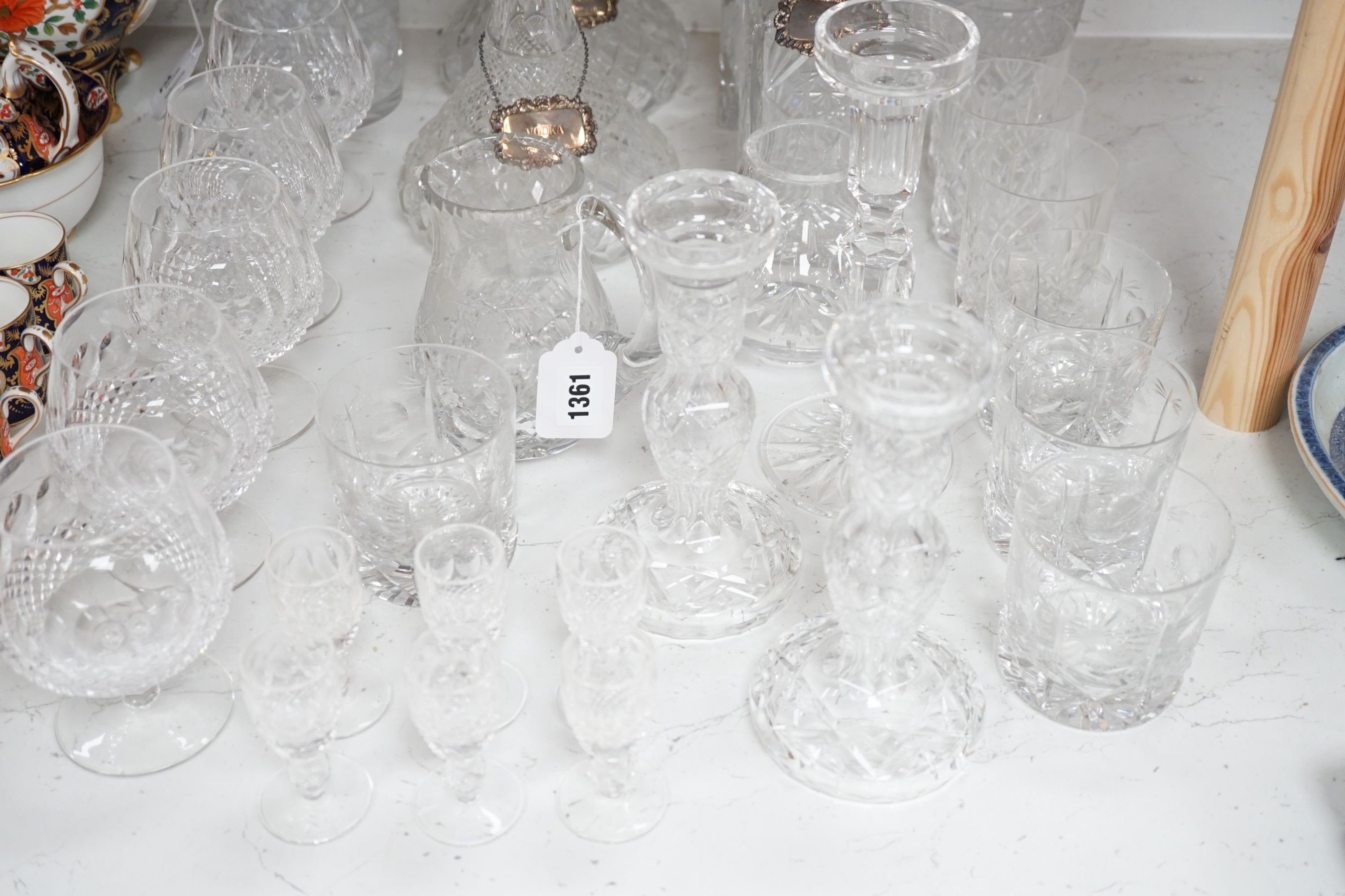 Assorted glassware including six decanters, each with a modern silver wine label